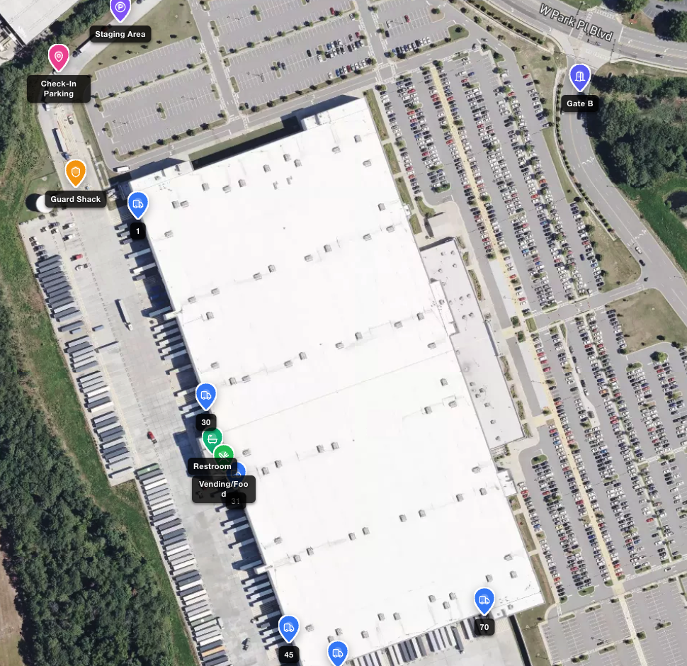 Aerial view of a distribution center with labeled pins for the guard shack, check-in parking, staging area, gate, numbered dock doors, restroom and vending